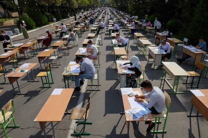 Estudiantes uzbecos asisten a los exámenes de ingreso a la universidad, al aire libre, en una calle de Tashkent con motivo de la pandemia.