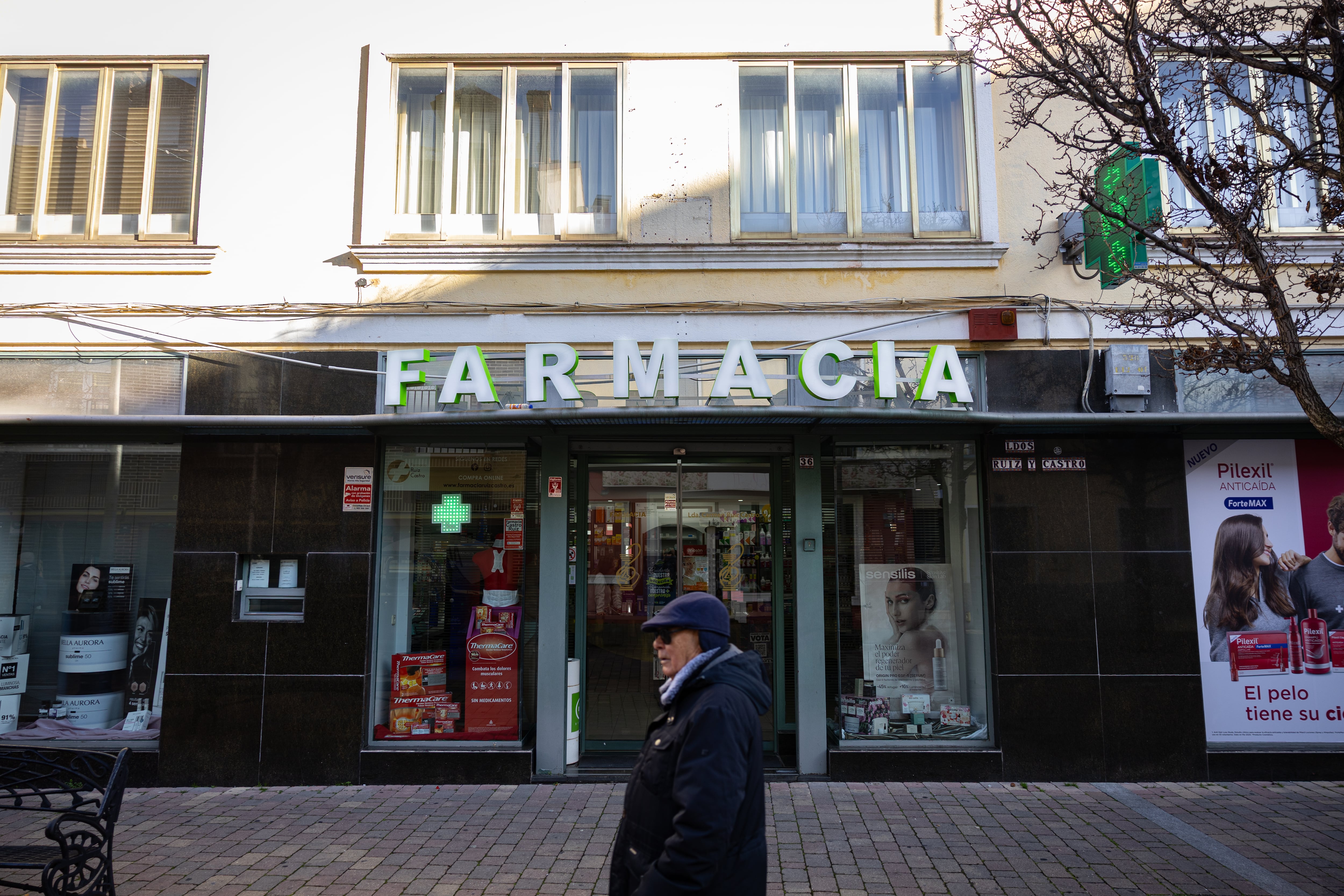 Un vecino de Fuenlabrada camina frente a la farmacia, el jueves.