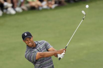 Tiger Woods golpea la bola en el segundo hoyo.