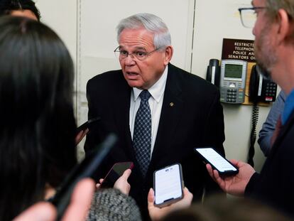 Sen. Bob Menendez, D-N.J., is surrounded by reporters as he walks on Capitol Hill, Tuesday, May 10, 2022, in Washington.