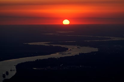 Ships travel along the Mississippi River in LaPlace, La., as the sun sets on Oct. 20, 2023.