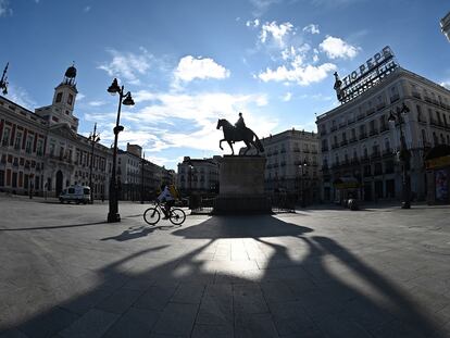 Entregador atravessa de bicicleta a habitualmente movimentada praça Puerta del Sol, no centro de Madri, no sábado passado.