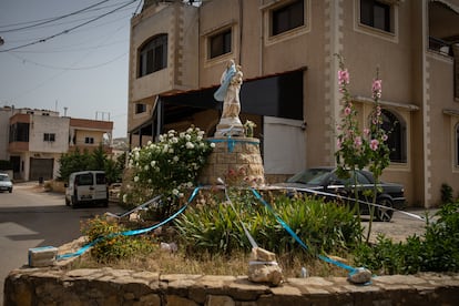Statue of the Virgin Mary with the baby Jesus in her arms, on a roundabout in Rmeish.