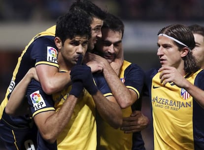 Athlético de Madrid striker Diego Costa is congratulated by his teammates after scoring a goal.