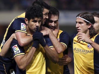 Athlético de Madrid striker Diego Costa is congratulated by his teammates after scoring a goal.