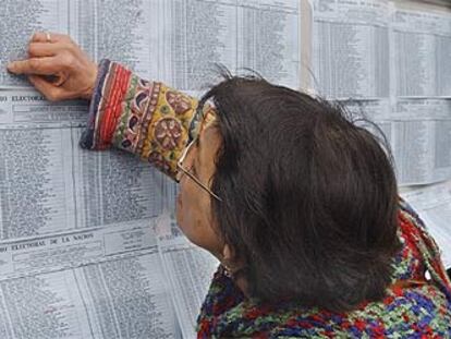 Una mujer busca su nombre en el censo electoral antes de votar, ayer en Buenos Aires.