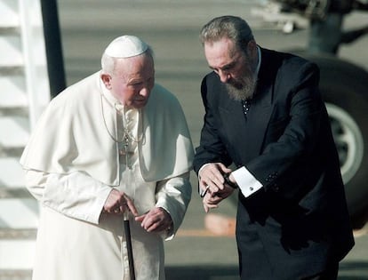 Fidel Castro olha as horas em seu relógio enquanto caminha com o papa João Paulo II no aeroporto internacional José Martí, em Havana, capital de Cuba, no dia 20 de janeiro de 1998.