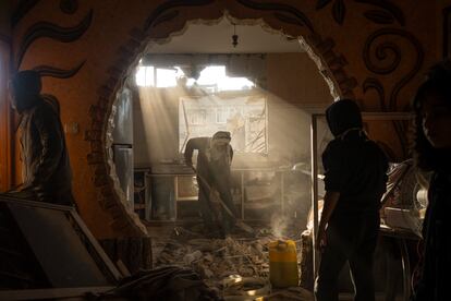 Palestinians look at their neighbour's damaged house following an Israeli strike in Rafah on Saturday, Jan. 27, 2024.