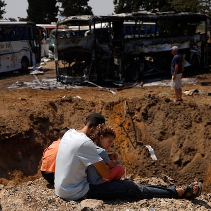 HERZLIYA, ISRAEL - JUNE 17: People look at a crater in the ground after a missile strike on June 17, 2025 in Herzliya, Israel. Iran launched a wave of retaliatory missile strikes on Israel starting late on June 13, after a series of Israeli airstrikes earlier in the day targeted Iranian military and nuclear sites, as well as top military officials. The two countries have continued to trade volleys of missiles in the days since. (Photo by Amir Levy/Getty Images)