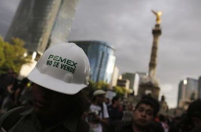 A protestor wears a hardhat that reads: "Pemex is not for sale."