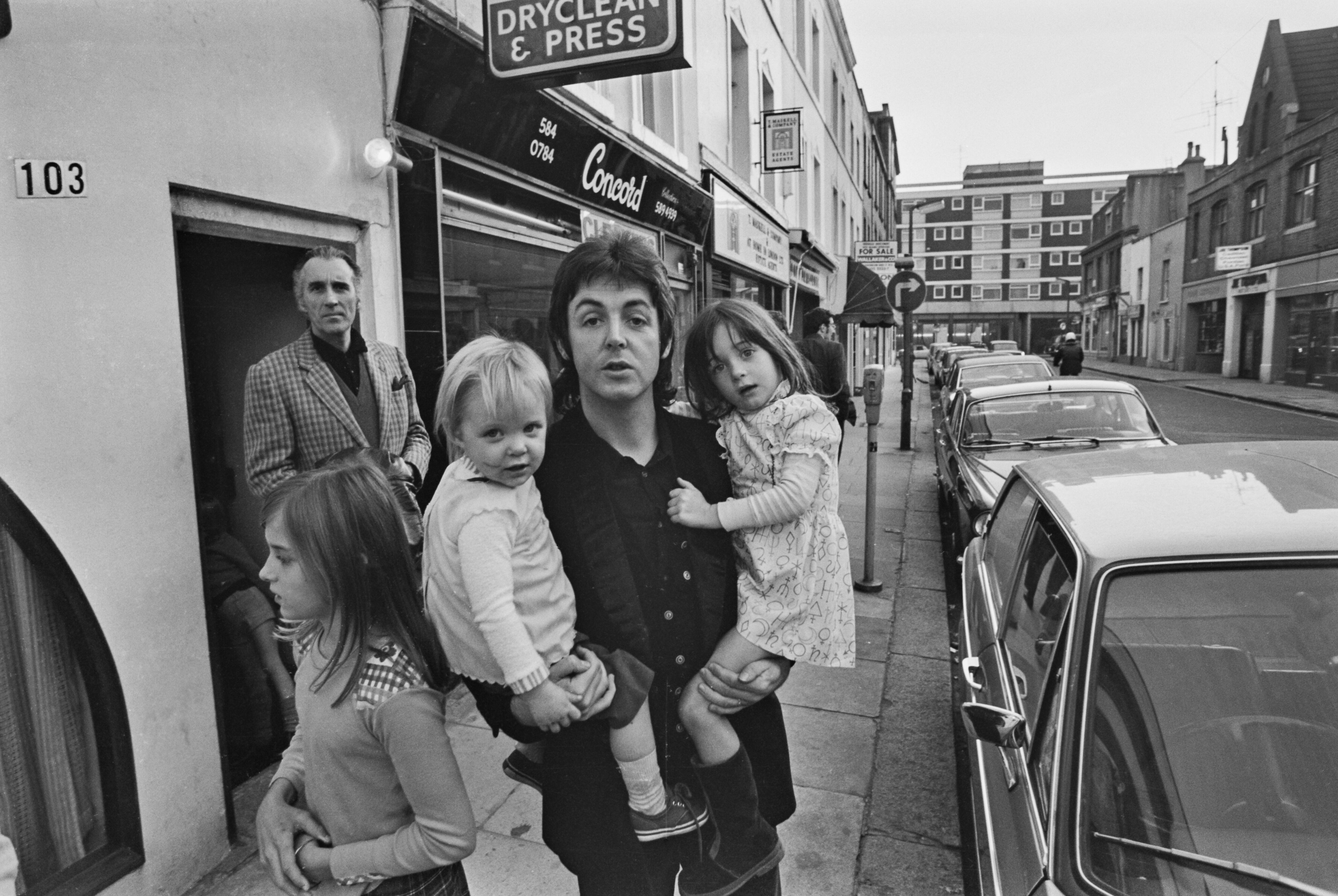 Paul McCartney con sus hijas en Londres en 1973. Al fondo, Christopher Lee.