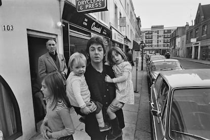 Paul McCartney with his children in London in 1973, with Christopher Lee in the background.