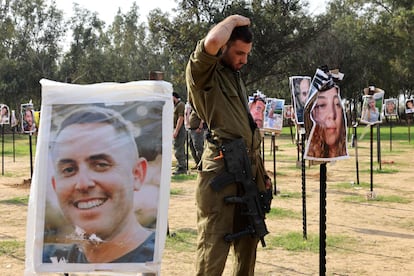 Israeli soldiers pay tribute to victims of the Reim music festival following an attack by Hamas on October 7, near kibbutz Reim in southern Israel on Sunday. 