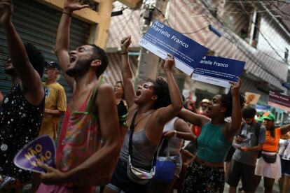 Foliões desfilam com placas em homenagem a vereadora Marielle Franco, no Complexo da Maré, no Carnaval 2019. 