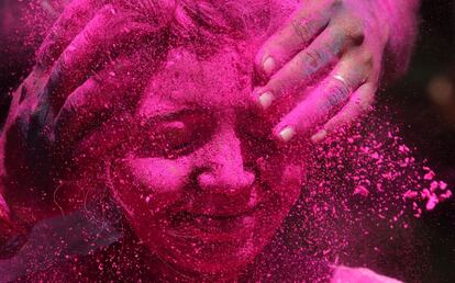 Una mujer se deja manchar la cara con polvos de colores en la ciudad india de Bombay, el 6 de marzo de 2015.