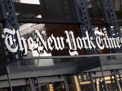 A sign for 'The New York Times' hangs above the entrance to its building, in New York.
