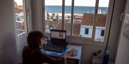A woman works remotely from home during the coronavirus lockdown in Spain.