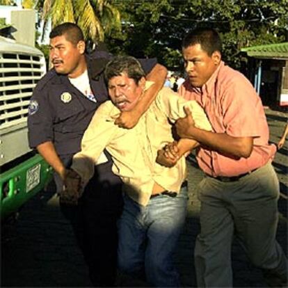 La policía detiene a un hombre durante las protestas protagonizadas por partidarios del ex presidente en Managua.