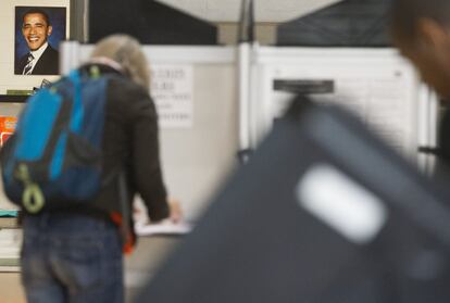 Una fotografía del presidente de Estados Unidos, Barck Obama, colgada junto a las cabinas donde los ciudadanos eligen sus papeletas antes de emitir el voto en un centro electoral de Washington DC.