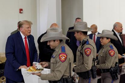 Former U.S. President Donald Trump serves meals to Texas Department of Public Safety (DPS) troopers at the South Texas International airport in Edinburg, Texas, U.S. November 19, 2023.