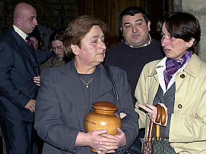 La madre del escolta Joseba Andoni Urdaniz, fallecido en un tiroteo con la Guardia Civil, porta la urna con las cenizas de su hijo.