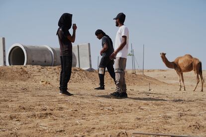 Residents of Al Bat, a Bedouin village not recognized by Israel, next to a concrete tube that serves as a bomb shelter installed after a Hamas rocket killed four children on the morning of October 7.