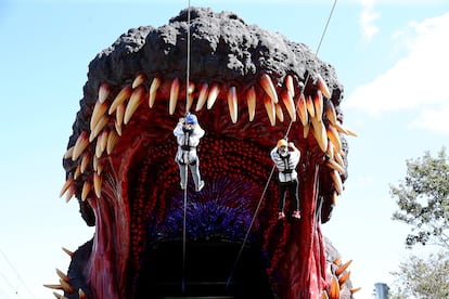 Visitors zipline between Godzilla's teeth at a theme park in Japan, circa 2020.
