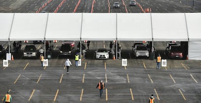 Cars make their way through lines of cones as they arrive for a UCHealth drive-up mass COVID-19 vaccination event in the parking lots of Coors Field on Sunday, Jan. 24, 2021, in Denver, Colo. (Helen H. Richardson/The Denver Post via AP)