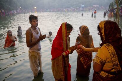 Hindu devotees perform rituals in a pond during Chhath Puja festival in New Delhi, India, Thursday, Oct. 26, 2017. During Chhath, an ancient Hindu festival, rituals are performed to thank the Sun god for sustaining life on earth. (AP Photo/Tsering Topgyal)