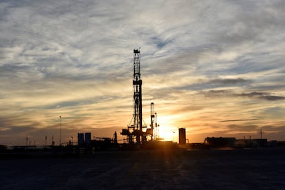 Drilling rigs operate at sunset in Midland, Texas