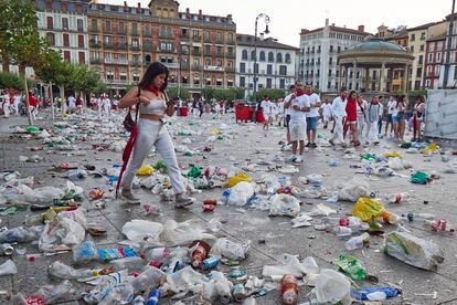 Una mujer camina entre la basura, a 9 de julio de 2023, en Pamplona, Navarra (España).