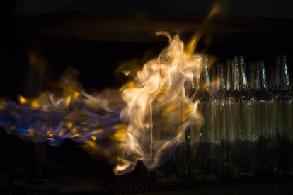 In this Tuesday, Jan. 26, 2016 photo, glass bottles move on the production line at the Phoenicia Glass Works Ltd. factory in the southern Israeli town of Yeruham. About 250 employees keep the factory running 24 hours a day, every day of the year. They even work on Yom Kippur, Judaismx92s holiest day, when everything else in the country grinds to a halt. They canx92t turn off the ovens, because the molten glass lava will harden and clog them.  (AP Photo/Oded Balilty)