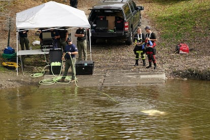 Members of law enforcement search a river, as the search for the suspect in the deadly mass shootings in Lewiston continues, in Lisbon Falls, Maine