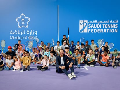 Nadal poses with a group of children at the Mahd Academy in Riyadh on December 10.