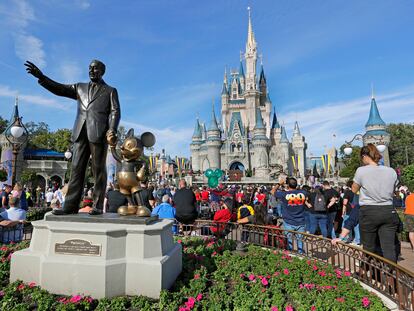 In this Jan. 9, 2019 photo, guests watch a show near a statue of Walt Disney and Micky Mouse in front of the Cinderella Castle at the Magic Kingdom at Walt Disney World in Lake Buena Vista, Fla.