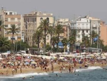 Imagen de una playa de Barcelona plagada de turistas