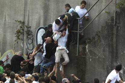 La policía rescata a una mujer por unas escaleras.