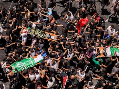 Decenas de personas llevan los cuerpos de los palestinos muertos en los enfrentamientos del día anterior en la operación militar israelí durante el funeral en Yenín, este 5 de julio.