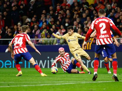 Pedri se lleva el balón ante Griezmann durante el partido entre el Atlético y el Barcelona este domingo.