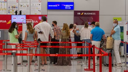 Passengers in Palma de Mallorca airport in the Balearic Islands line up for a flight to the UK on Sunday.
