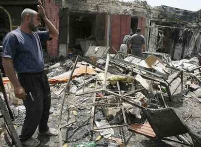 Un hombre mira las ruinas de su tienda, destruida ayer por un coche bomba que mató a 35 personas en Bagdad.