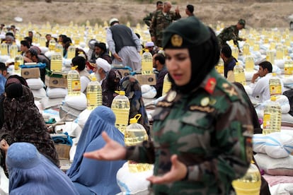 Una oficial del Ejército afgano durante un reparto de comida a las familias de los soldados muertos en combate, el lunes en la ciudad de Herat.