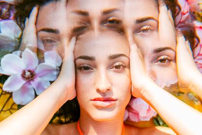 Multiple exposure of young woman with head in hands