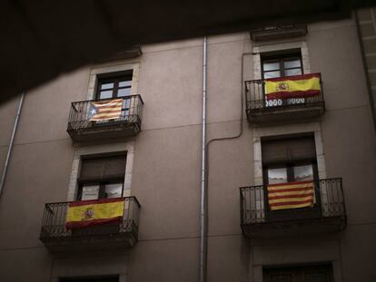 Banderas españolas, senyeras y esteladas en un balcón de Girona.