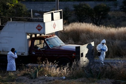 Police inspect an abandoned truck that was modified into a ram, found on the outskirts of Tula after a gang rammed several vehicles into a prison and escaped with nine inmates, in Tula, Mexico, Wednesday, Dec. 1, 2021. (AP Photo/Ginnette Riquelme)