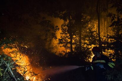 Miembros de protección civil de Vilagarcia luchan contra el fuego declarado en la zona de Castrogudin a las afueras de Vilagarcia (Galicia).
