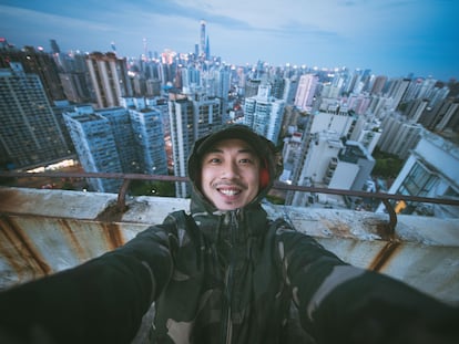 Retrato de un hombre en una azotea de Shanghai, China, usando la cámara gran angular de su teléfono móvil.