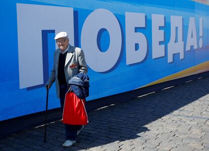 Un hombre camina frente a una pancarta que lee '¡Victoria!' en el centro de Moscú. 