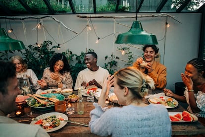 Cheerful business colleagues having dinner together in garden