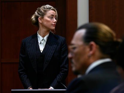 Actors Amber Heard and Johnny Depp, watch the jury arrive in the courtroom at the Fairfax County Circuit Courthouse in Fairfax, Va., Tuesday, May 17, 2022. Depp sued his ex-wife Amber Heard for libel in Fairfax County Circuit Court after she wrote an op-ed piece in The Washington Post in 2018 referring to herself as a "public figure representing domestic abuse." (Brendan Smialowski/Pool photo via AP)